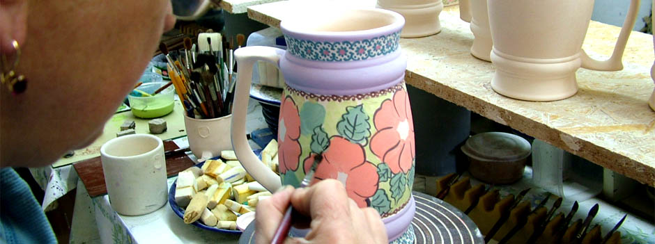 View inside a kiln with several Polish pottery cups.